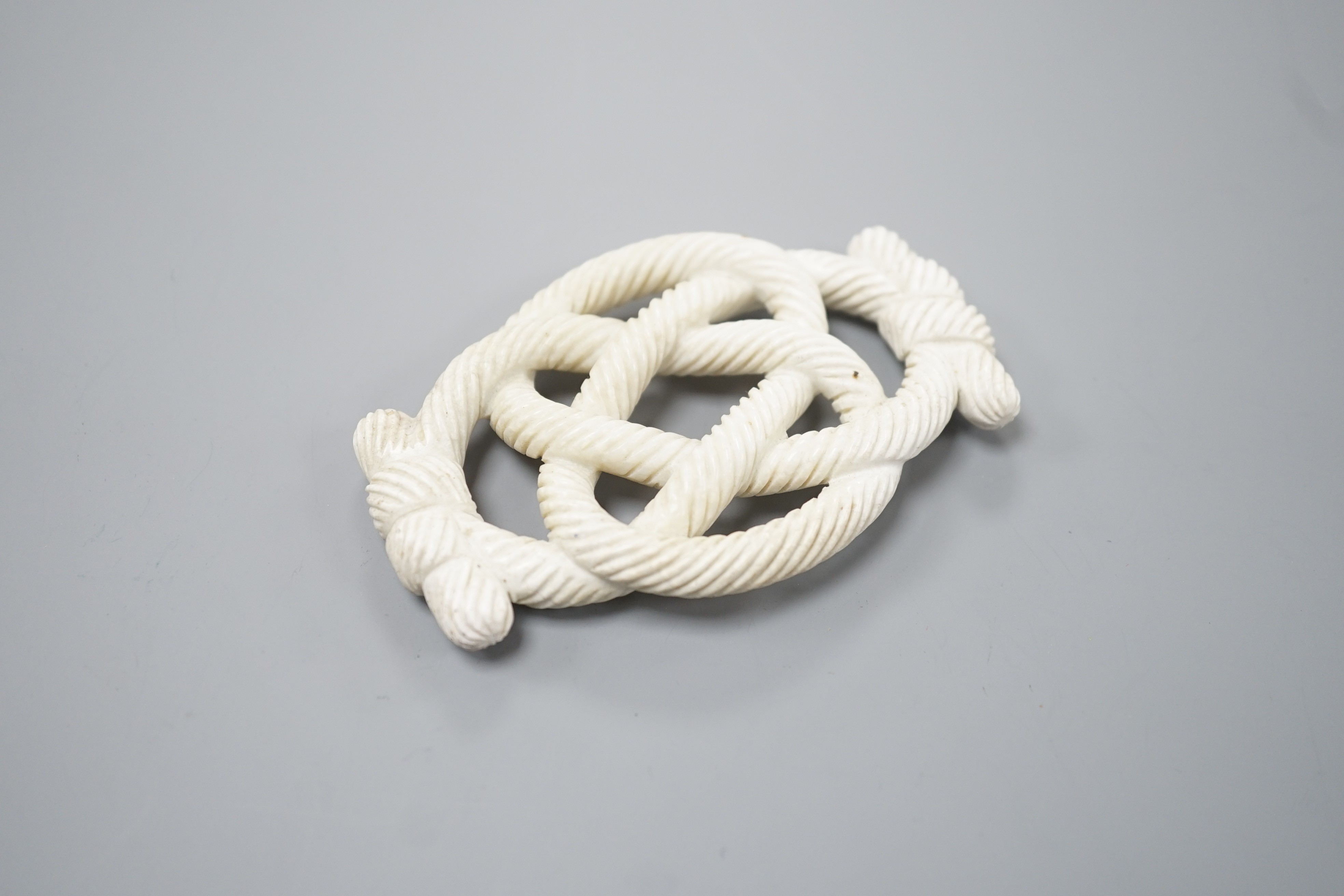 A Chinese hardstone eternal knot carving, 19th century, possibly burnt jade, 8.4cm